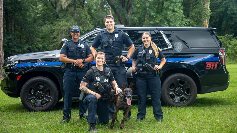 officers standing in front of a patrol vehicle